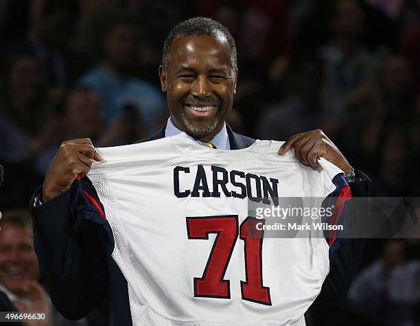 Republican President candidate Dr. Ben Carson holds a jersey presented to him during a campaign rally at Liberty University, on November 11, 2015 in...