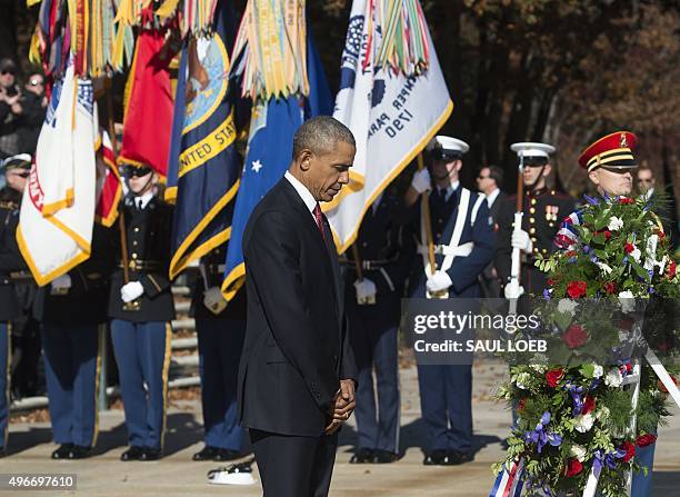 President Barack Obama pauses for a moment of silence as he participates in a wreath laying ceremony at the Tomb of the Unknown Soldier in honor of...