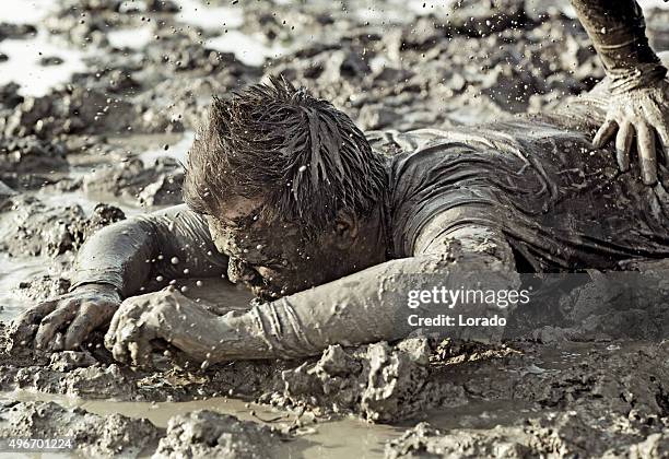 close up of two man fighting in mud - mud wrestling stock pictures, royalty-free photos & images