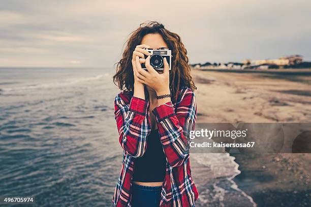 girl taking a photo at sea with a film camera - girl camera bildbanksfoton och bilder