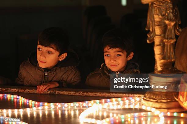 Young boys look at a light installation as people gather to celebrate the Hindu festival of Diwali on November 11, 2015 in Leicester, United Kingdom....