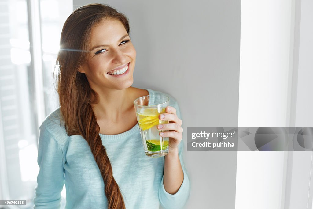 Healthy Lifestyle And Food. Woman Drinking Fruit Water. Detox.
