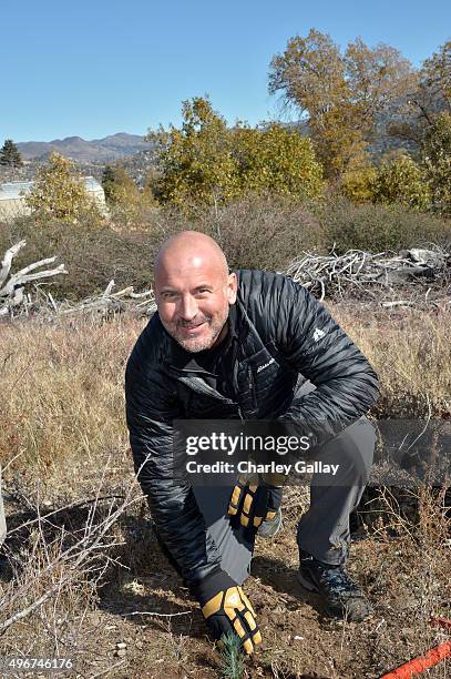 Eddie Bauer President and CEO Mike Egeck poses with the 50 millionth Tree planted in celebration of 20-Year partnership with American Forests on...