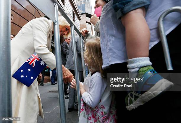 Camilla, Duchess of Cornwall meets three-year-old Alexandra Denezis as the duchess and Prince Charles meet well-wishers during a walk around Sydney's...
