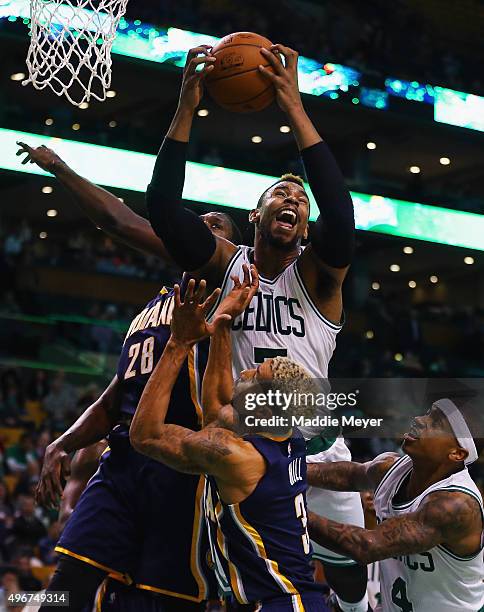 Jared Sullinger of the Boston Celtics grabs a rebound over Ian Mahinmi of the Indiana Pacers during the fourth quarter at TD Garden on November 11,...