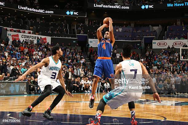 Arron Afflalo of the New York Knicks shoots against Jeremy Lamb of the Charlotte Hornets and Jeremy Lin of the Charlotte Hornets on November 11, 2015...