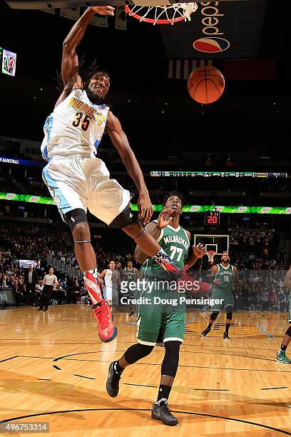 Kenneth Faried of the Denver Nuggets dunks the ball against Johnny O'Bryant III of the Milwaukee Bucks at Pepsi Center on November 11, 2015 in...