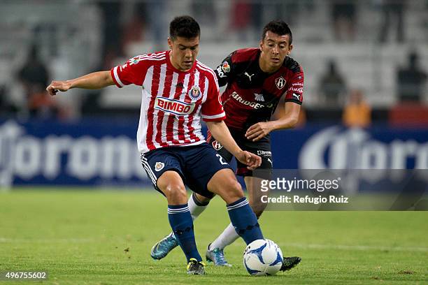 Daniel Alvarez of Atlas battles for the ball with Michael Perez of Chivas during the 14th round match between Atlas and Chivas as part of the...