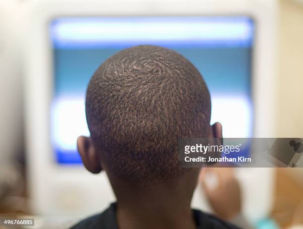 fourth grade boy works on computer. - back of heads stock pictures, royalty-free photos & images