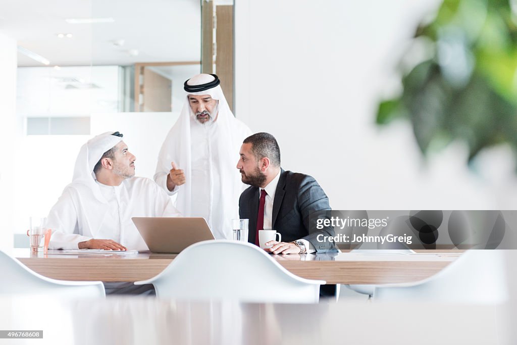 Three Arab businessmen in business meeting in modern office