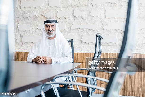 mature arab businessman in traditional clothing in modern office - ghoutra stock pictures, royalty-free photos & images