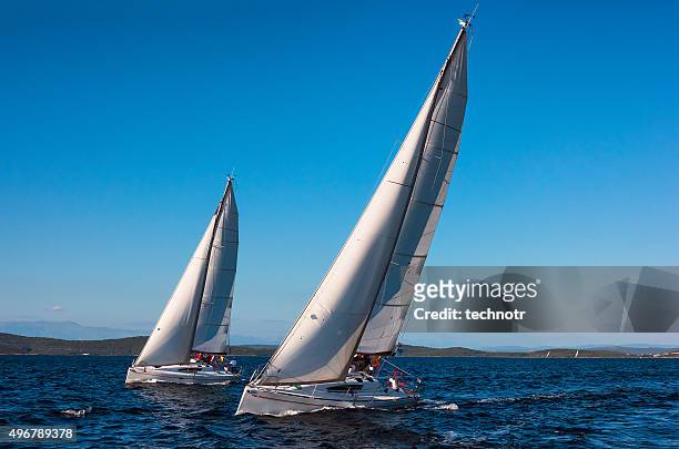 two beautiful sailboats racing  at regatta - regatta stock pictures, royalty-free photos & images