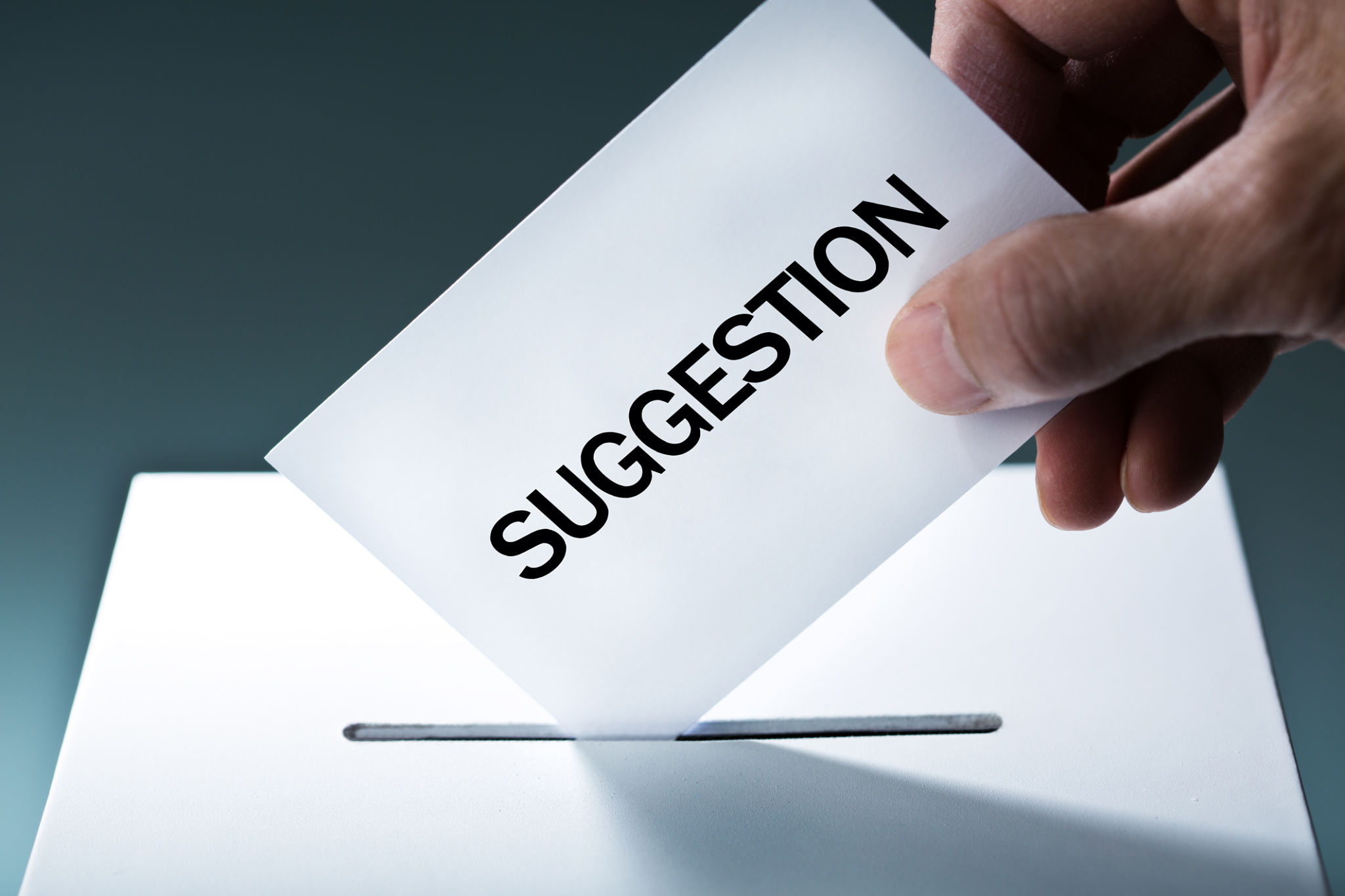 Hand Inserting Suggestion into Suggestion Box Hand Inserting Suggestion into Suggestion Box