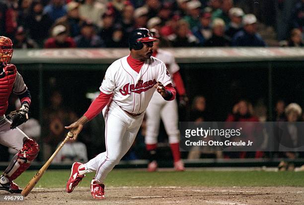 Eddie Murray of the Cleveland Indians drops his bat after making the game winning hit during a game against the Atlanta Braves at the Jacobs Field in...