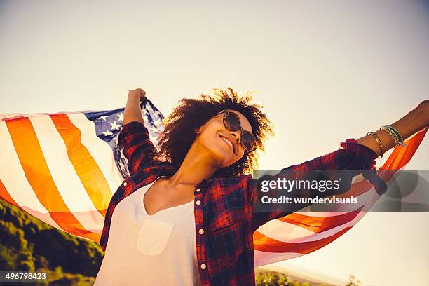 girl is waving american flag - afro amerikaanse cultuur stockfoto's en -beelden