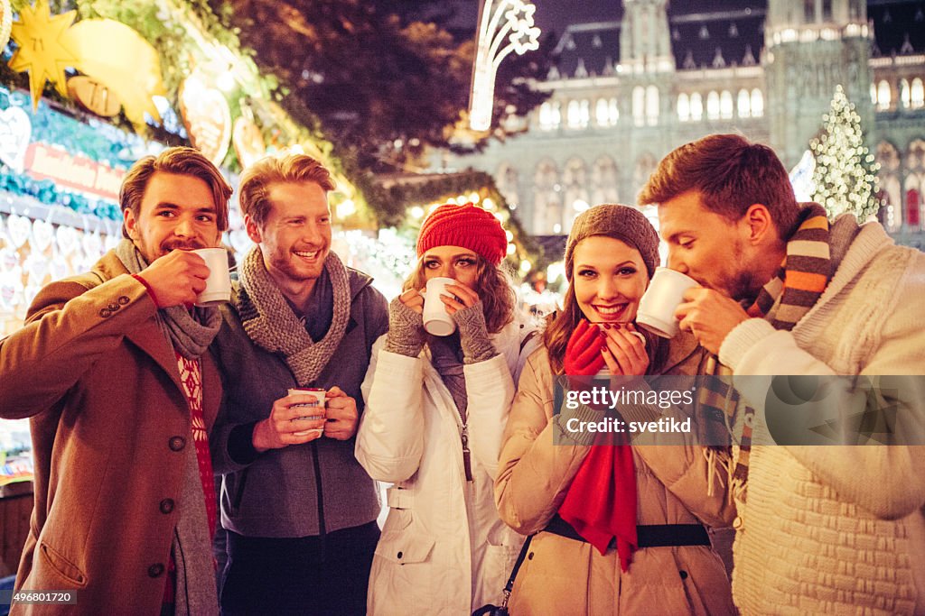 Friends having fun outdoors at winter holidays.