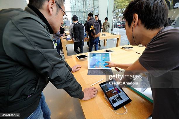 An apple shop assistant demonstrates an Ipad pro at the Apple store of the High-end shopping district of Omotesando in Tokyo, Japan on November 12,...