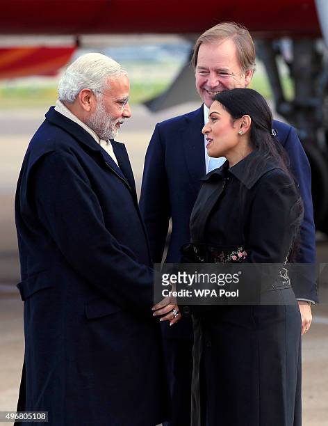 Indian Prime Minister Narendra Modi is greeted by greeted by Minister of State for the Foreign and Commonwealth Office, Hugo Swire and MP Priti Patel...