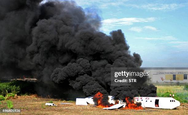 Mock plane is set on fire during the Crash-Rescue Exercise at the Manila International Airport in Manila on November 12, 2015. The drill was held as...