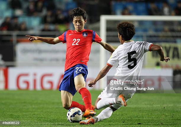 Lee Jae-Sung of South Korea competes for the ball with Nanda Kyaw of Myanmar during the 2018 FIFA World Cup Qualifier Round 2 Group G match between...