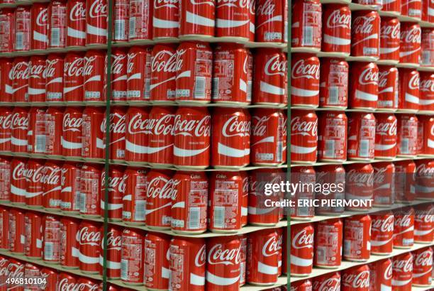 This photo taken on November 12, 2015 in Grigny, near Paris, shows newly produced Coca-Cola soft drink cans near the new assembly line at a Coca-Cola...