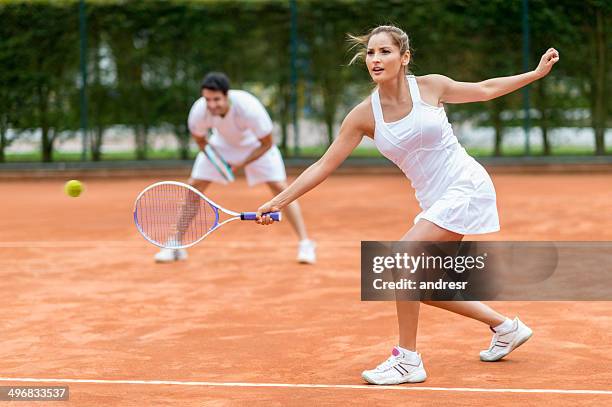 couple playing tennis - doubles stock pictures, royalty-free photos & images