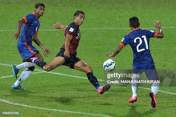 India's Narayan Das and Arnab Kumar Mondal look on as Guam's forward Marcus Lopez takes the ball during the the Asia Group D FIFA World Cup 2018...