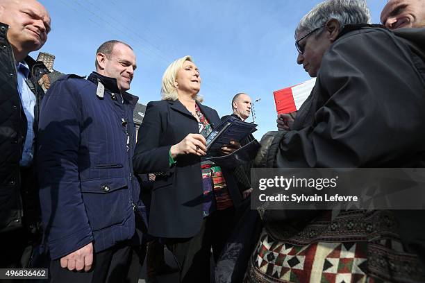 French Far-Right National Front President Marine Le Pen distributes leaflets at a market in Somain, near the French northern city of Douai on...