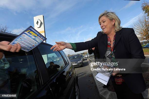 French Far-Right National Front President Marine Le Pen distributes campaign leaflets at the main entrance of french car maker Renault factory on...