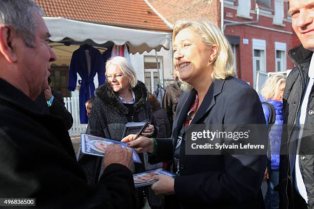 French Far-Right National Front President Marine Le Pen distributes leaflets at a market in Somain, near the French northern city of Douai on...