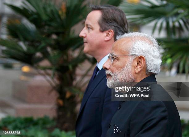 British Prime Minister David Cameron and India's Prime Minister Narendra Modi leave after paying homage to the statue of Mahatma Ghandi in Parliament...