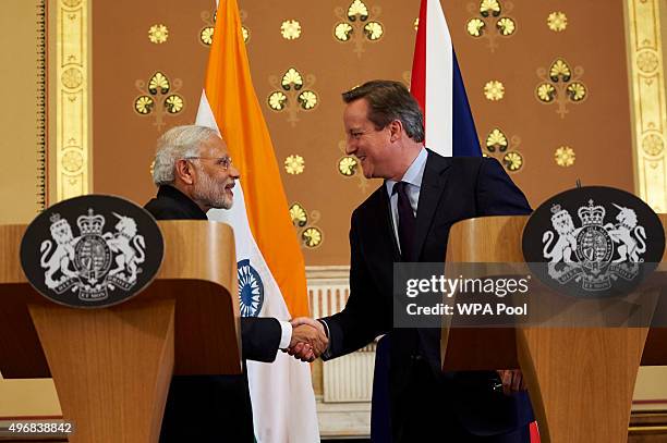 British Prime Minister David Cameron shakes hands with India's Prime Minister Narendra Modi after a joint press conference at the Foreign Office...