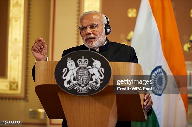 India's Prime Minister Narendra Modi speaks with British Prime Minister David Cameron during a joint press conference at the Foreign Office during an...