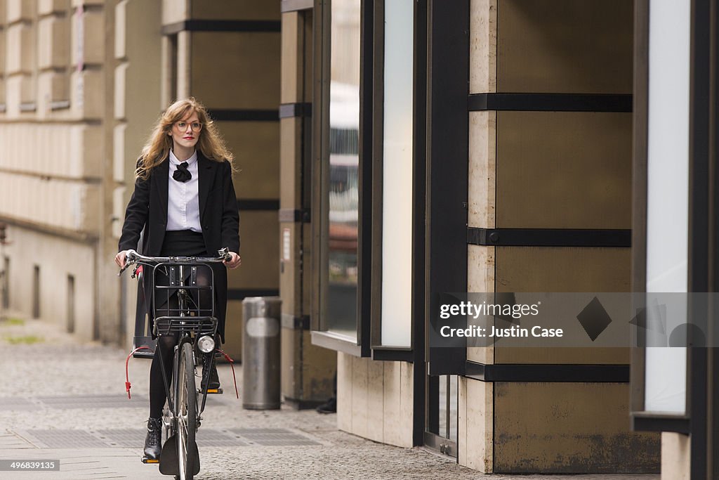 Business woman riding a bike in the city