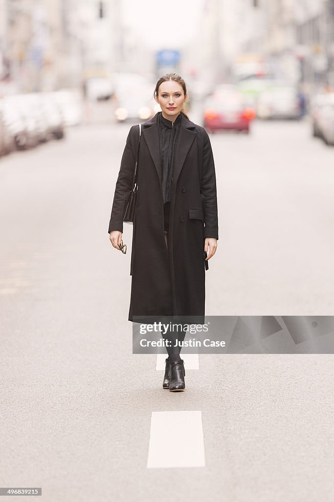 Classy business woman standing on a city road