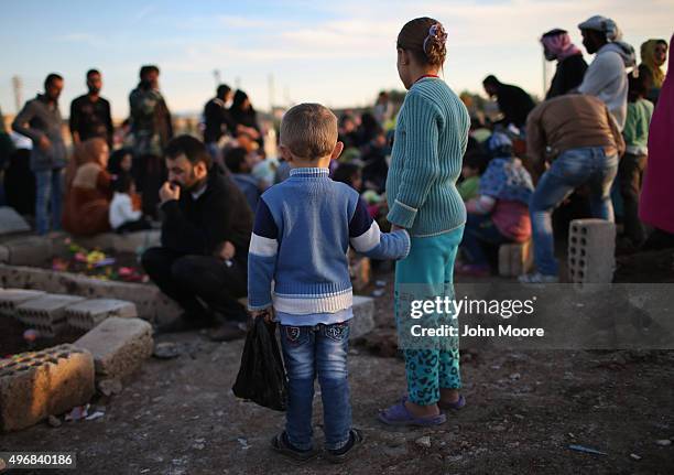 Family members pay their respects in a martyrs' cemetery for soldiers from the People's Protection Units , killed fighting ISIL on November 12, 2015...