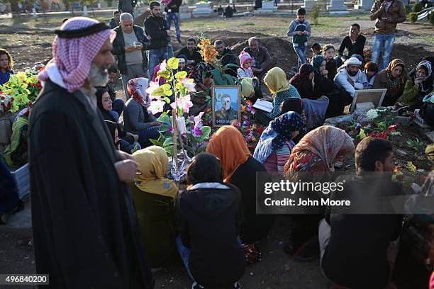 Family members pay their respects in a martyrs' cemetery for soldiers from the People's Protection Units , killed fighting ISIL on November 12, 2015...