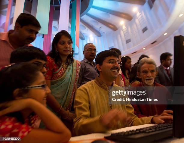 Brokers, along with their families, trade as ceremonial purchases of stocks are made during the special Muhurat Trading session on the occasion of...