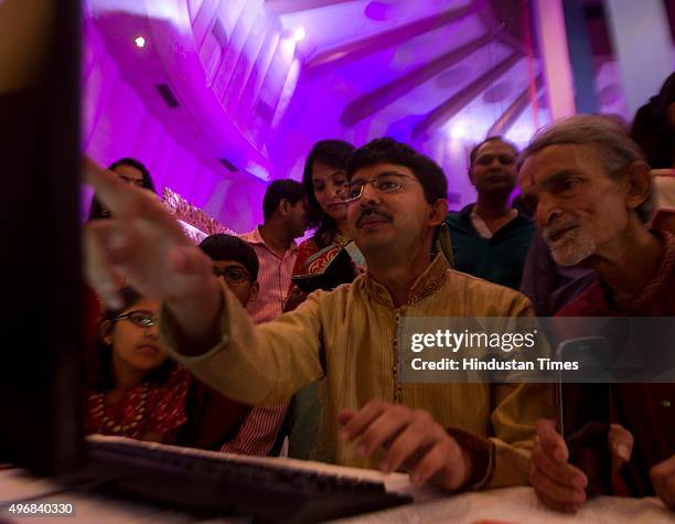 Brokers, along with their families, trade as ceremonial purchases of stocks are made during the special Muhurat Trading session on the occasion of...