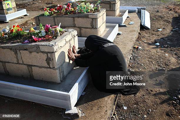 Family member pays her respects in a martyrs' cemetery for soldiers from the People's Protection Units , killed fighting ISIL on November 12, 2015 in...