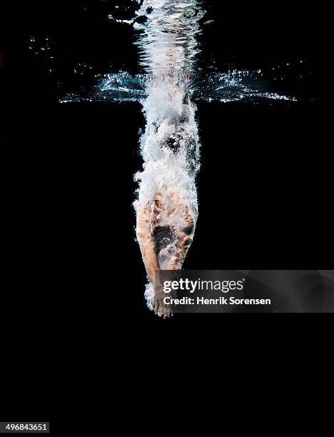 young swimmer breaking the surface - diving into water stock pictures, royalty-free photos & images