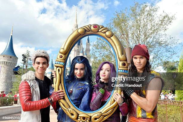 In this handout provided by Disney Parks, The cast of Disney Channel Original Movie 'Descendants' Cameron Boyce who plays Carlos, Sofia Carson who...