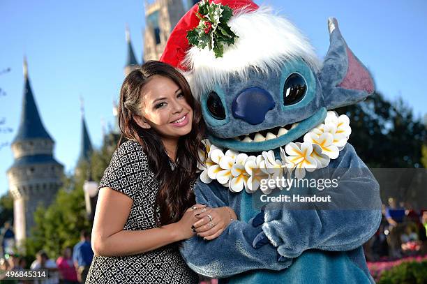 In this handout provided by Disney Parks, Actress Janel Parrish, one of the stars of "Pretty Little Liars" on ABC Family , poses with Stitch from...