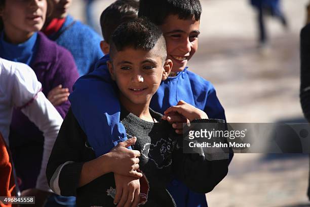 Students play during recess at a public elementary school on November 12, 2015 in Qamishli, Rojava, Syria. With the fall of the Syrian regime and...