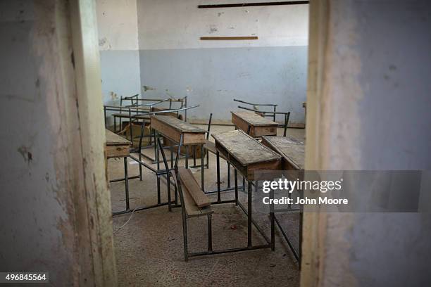 Broken desks sit in a classroom at a public elementary school on November 12, 2015 in Qamishli, Rojava, Syria. Although funds are short for school...