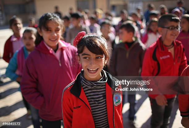 Students sing the Rojava anthem at a public elementary school on November 12, 2015 in Qamishli, Rojava, Syria. With the fall of the Syrian regime and...