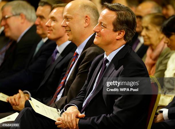 Britain's Prime Minister David Cameron smiles as he listens to Indian Prime Minister Narendra Modi deliver a speech in the Royal Gallery in the...