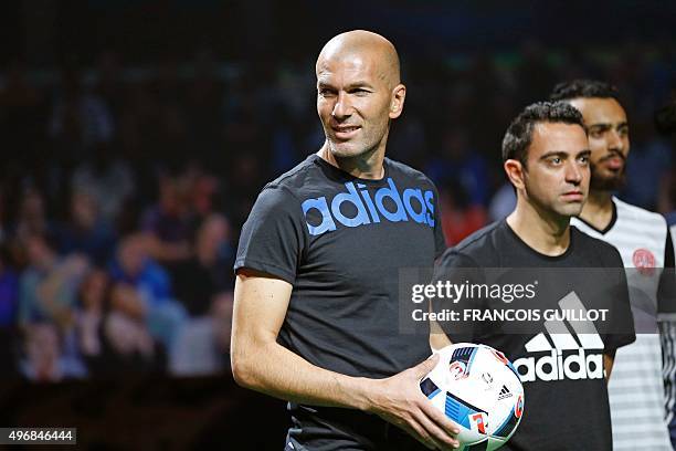 Former French soccer player Zinedine Zidane , holding the official football of the upcoming Euro 2016 football championship, poses with Spanish...