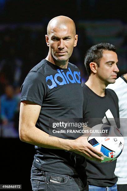 Former French soccer player Zinedine Zidane , holding the official football of the upcoming Euro 2016 football championship, poses with Spanish...