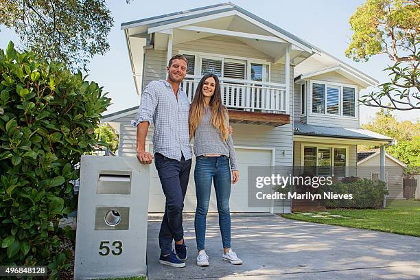 couple standing by their mailbox in front of new home - first home buyers stock pictures, royalty-free photos & images